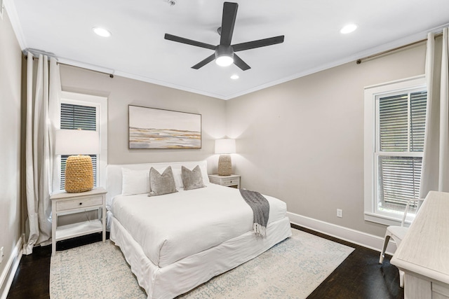 bedroom with ornamental molding, dark hardwood / wood-style floors, and ceiling fan