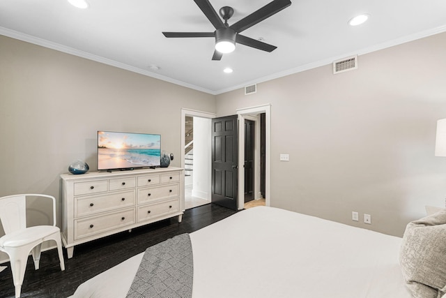 bedroom featuring crown molding, dark hardwood / wood-style floors, and ceiling fan