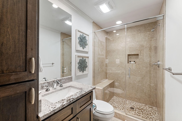 bathroom with large vanity, an enclosed shower, toilet, and ornamental molding