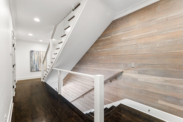 corridor with dark wood-type flooring and wooden walls