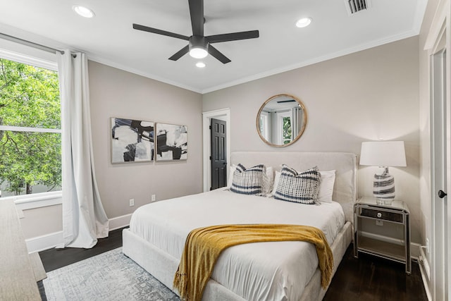 bedroom featuring crown molding, dark hardwood / wood-style flooring, and ceiling fan