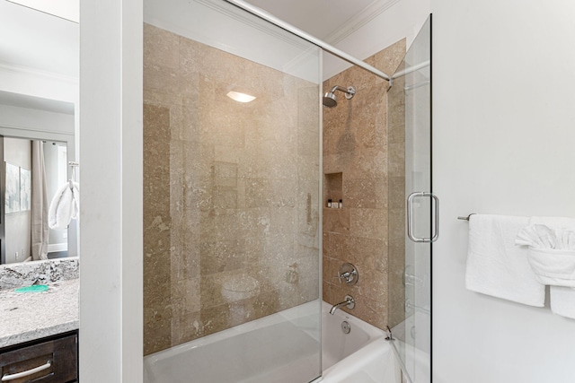 bathroom featuring crown molding, shower / bath combination with glass door, and vanity