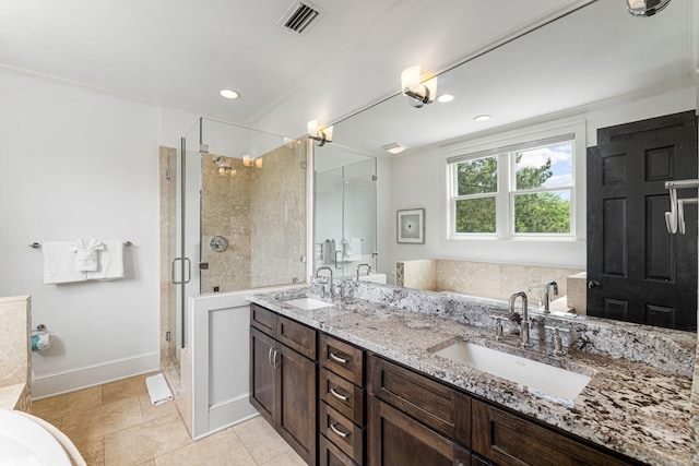 bathroom featuring ornamental molding, double vanity, an enclosed shower, and tile floors