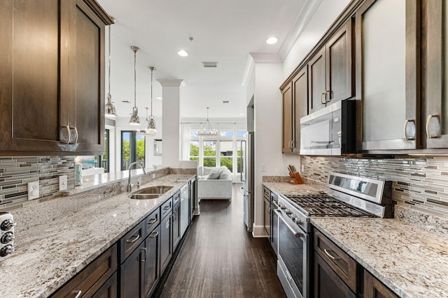 kitchen with dark hardwood / wood-style flooring, ornamental molding, stainless steel appliances, sink, and tasteful backsplash