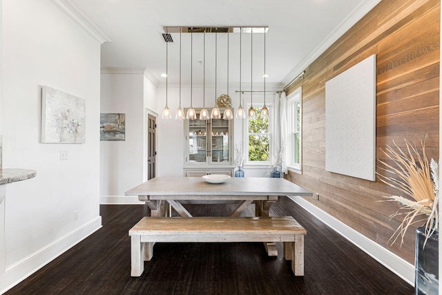 dining space featuring ornamental molding and dark wood-type flooring