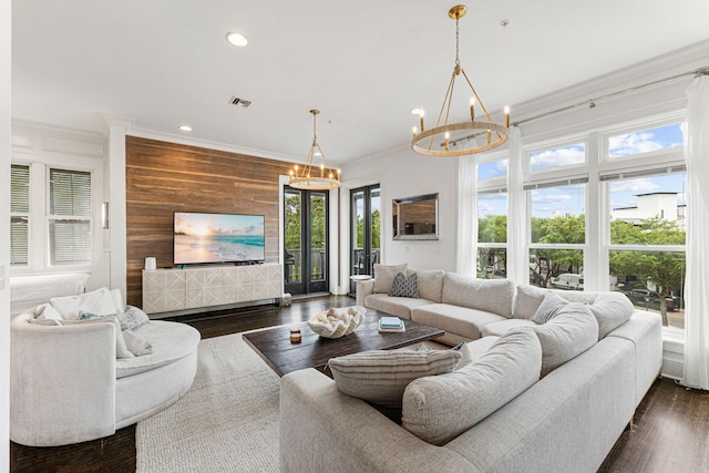 living room with wooden walls, a wealth of natural light, and dark wood-type flooring