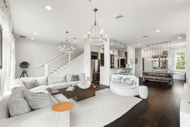 living room with a chandelier and dark hardwood / wood-style flooring