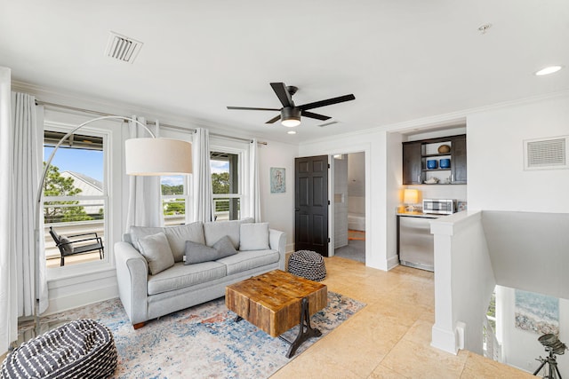 tiled living room with crown molding and ceiling fan