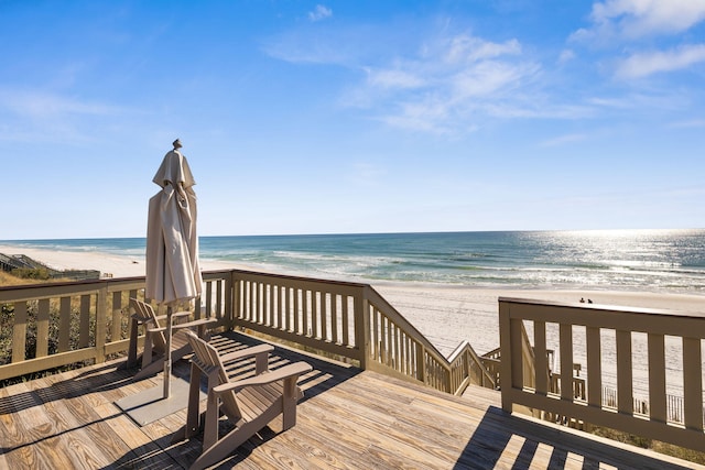 deck with a water view and a view of the beach