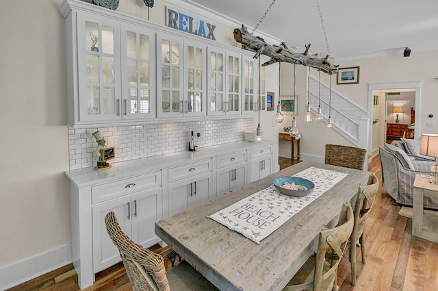 dining area featuring hardwood / wood-style floors and crown molding