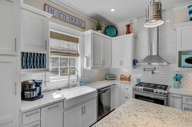 kitchen featuring pendant lighting, white cabinetry, appliances with stainless steel finishes, sink, and tasteful backsplash