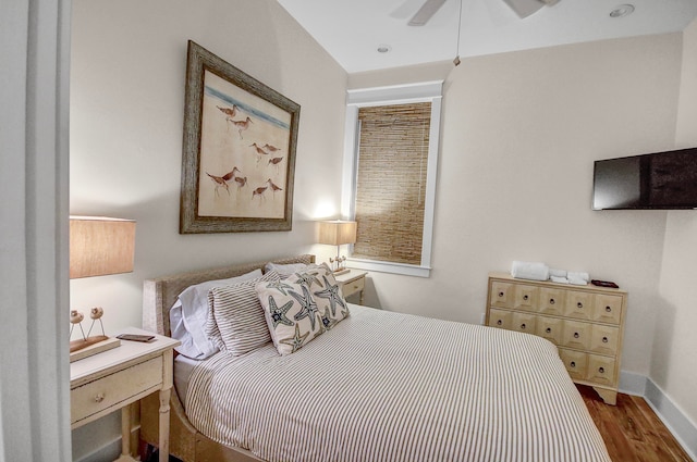 bedroom with ceiling fan and dark hardwood / wood-style floors