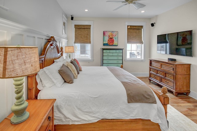 bedroom with light hardwood / wood-style floors and ceiling fan