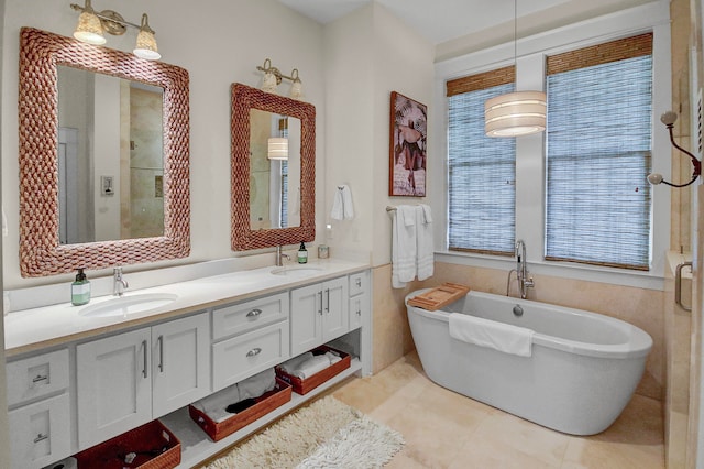 bathroom with dual bowl vanity, separate shower and tub, tile floors, and plenty of natural light