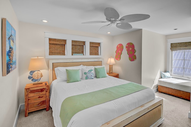 bedroom featuring light colored carpet and ceiling fan