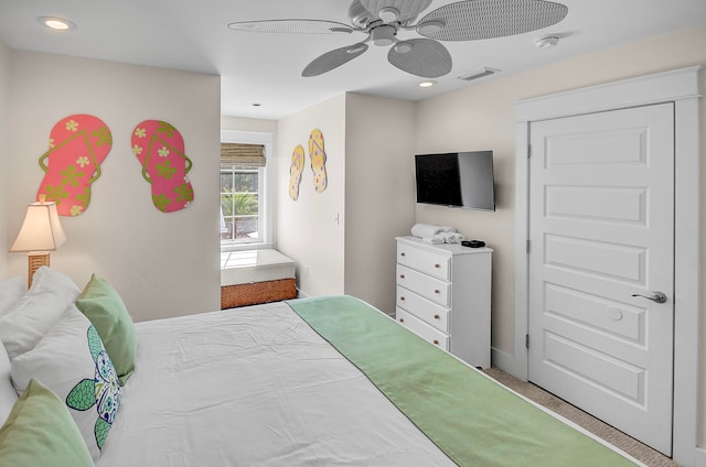 bedroom featuring ceiling fan and light carpet