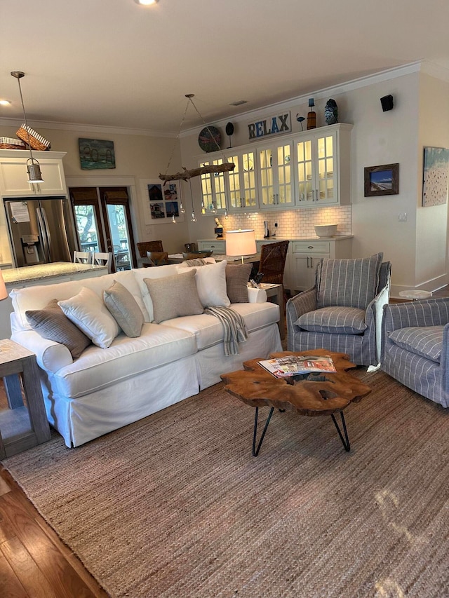 living room featuring ornamental molding and wood-type flooring