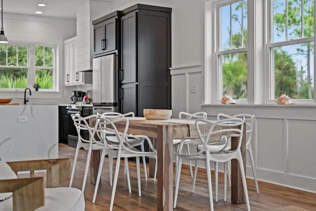 dining room featuring sink and light hardwood / wood-style flooring