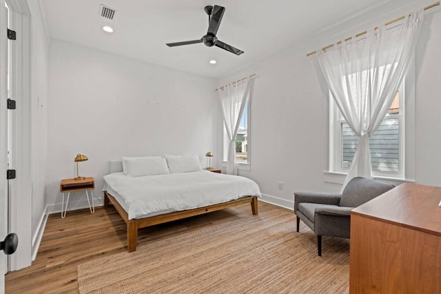 bedroom with light hardwood / wood-style flooring and ceiling fan