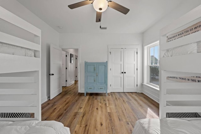 bedroom with light hardwood / wood-style flooring and ceiling fan