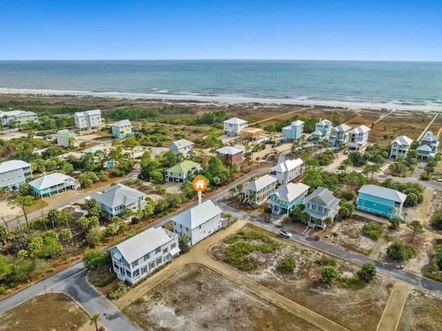 birds eye view of property with a water view and a view of the beach