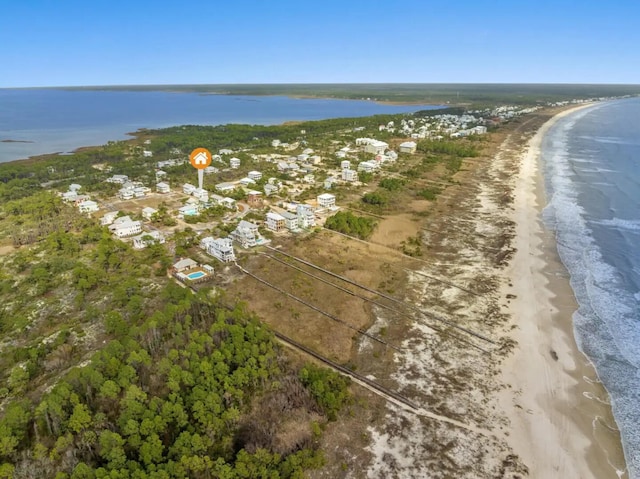 drone / aerial view featuring a view of the beach and a water view