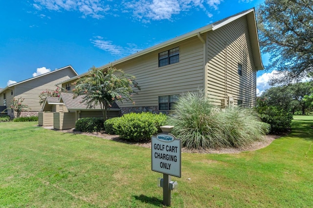 view of side of property with a lawn