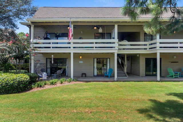 back of house featuring a patio, a balcony, ceiling fan, and a yard