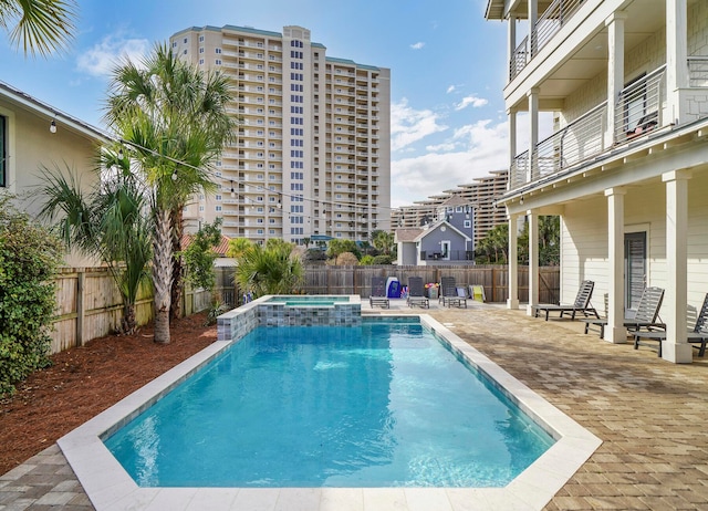 view of pool with an in ground hot tub and a patio area