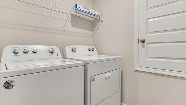 clothes washing area with separate washer and dryer