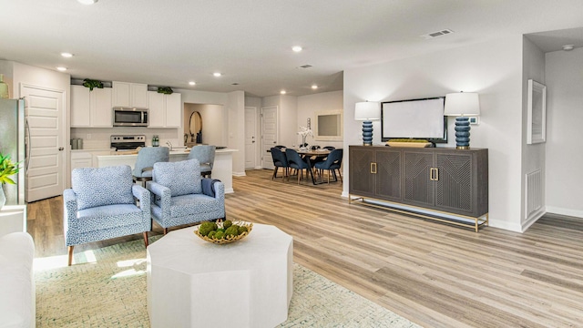 living room with light hardwood / wood-style floors