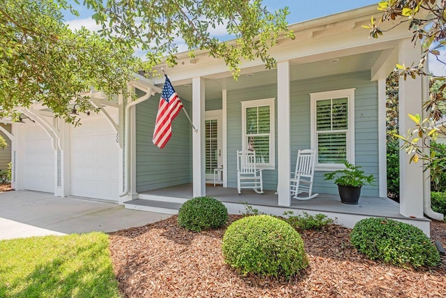 entrance to property featuring a porch and a garage