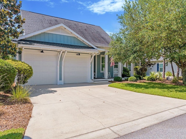 view of front of property featuring a garage and a front lawn