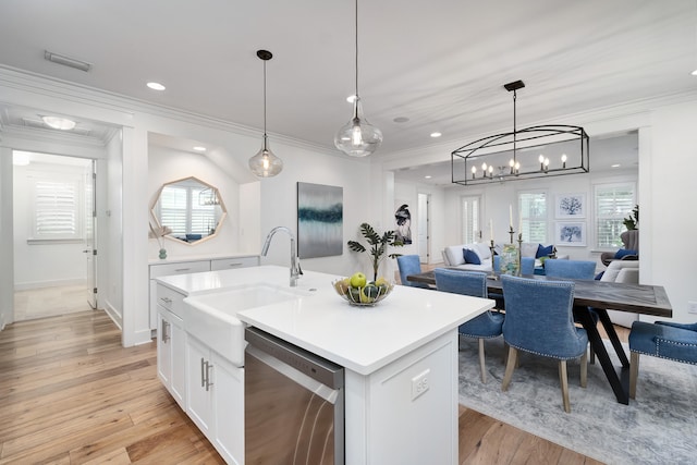 kitchen with sink, stainless steel dishwasher, pendant lighting, a kitchen island with sink, and white cabinets