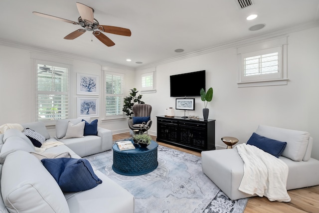 living room featuring crown molding, ceiling fan, and light hardwood / wood-style floors