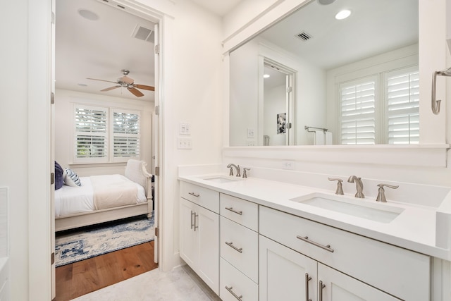 bathroom with wood-type flooring, vanity, and ceiling fan