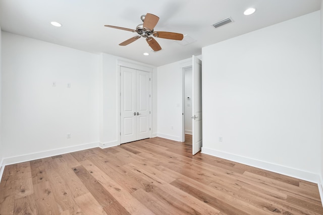 spare room with ceiling fan and light wood-type flooring