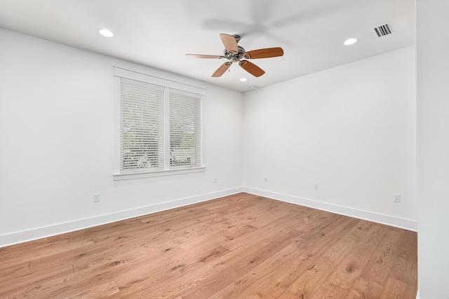 empty room featuring ceiling fan and light hardwood / wood-style flooring