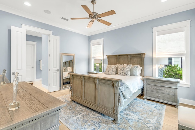 bedroom with crown molding, light hardwood / wood-style floors, and ceiling fan