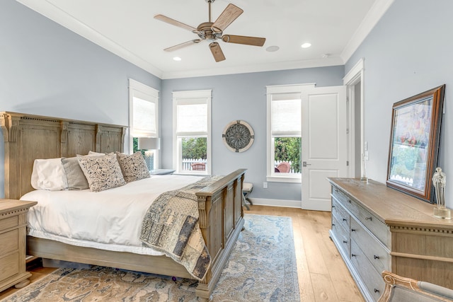 bedroom featuring ceiling fan, ornamental molding, and light hardwood / wood-style flooring