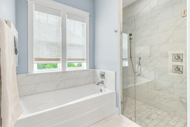 bathroom with tile patterned flooring and separate shower and tub