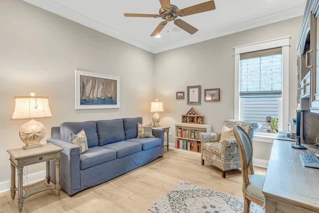 living room with ornamental molding, light wood-type flooring, and ceiling fan