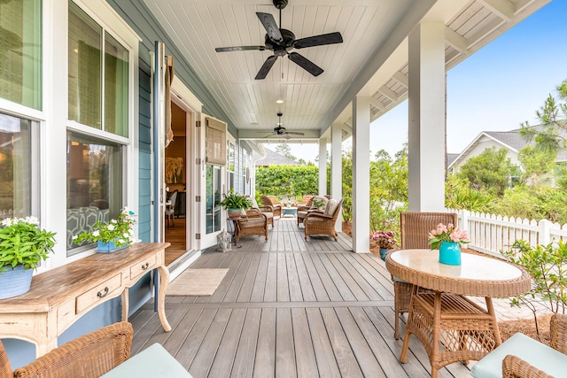 wooden deck with ceiling fan and an outdoor hangout area