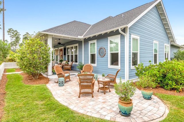 rear view of house featuring a patio, ceiling fan, and a lawn