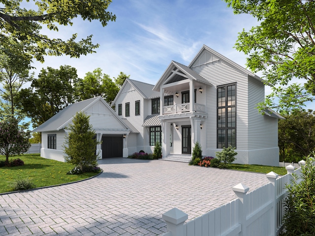 view of front of property featuring a garage, a balcony, and a front lawn