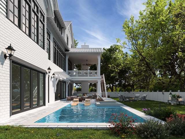 view of swimming pool featuring a jacuzzi and a patio