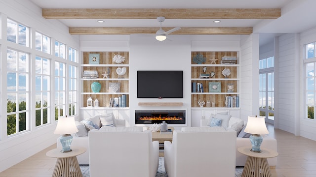 living room featuring a healthy amount of sunlight, light hardwood / wood-style flooring, and beam ceiling