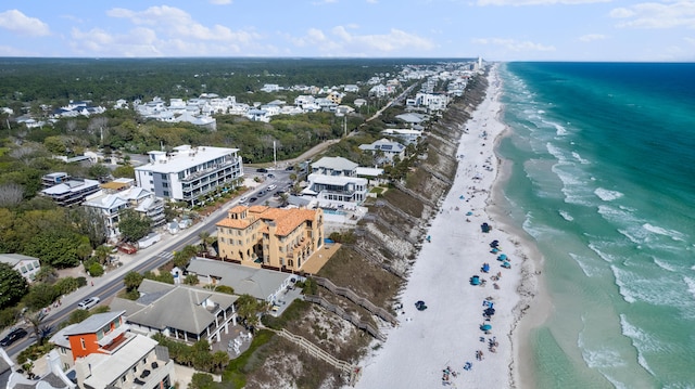 aerial view with a water view and a beach view