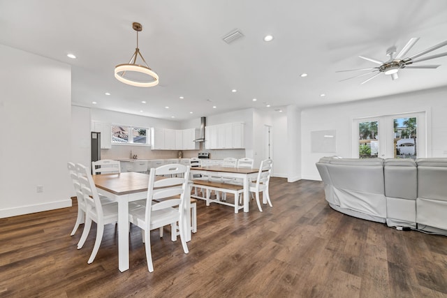 dining area with dark wood-type flooring, ceiling fan, and french doors