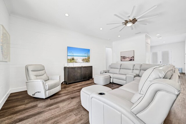 living room with dark hardwood / wood-style flooring and ceiling fan